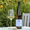 2018 Smith-Madrone Riesling photo of bottle and wine glass on table in front of lemon tree