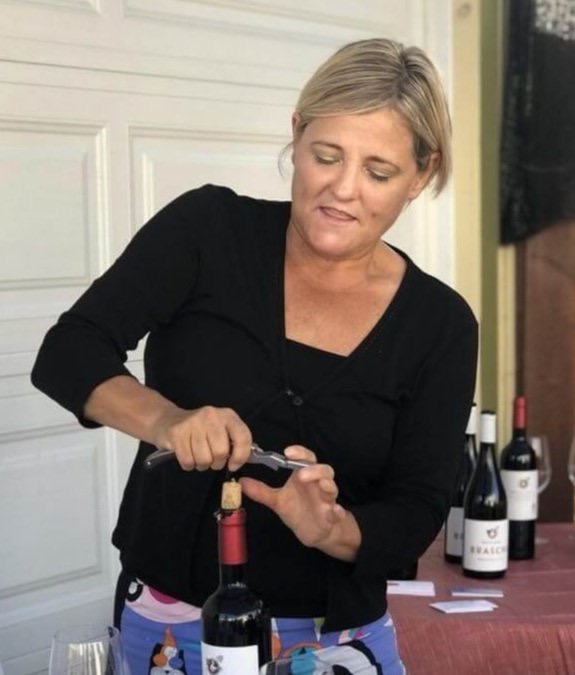 Sheila Donohue, founder and CEO VeroVino, photo opening a bottle of wine