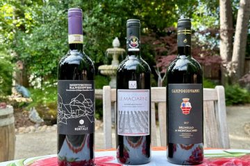 Photo of three bottles of Tuscan Sangiovese in garden setting