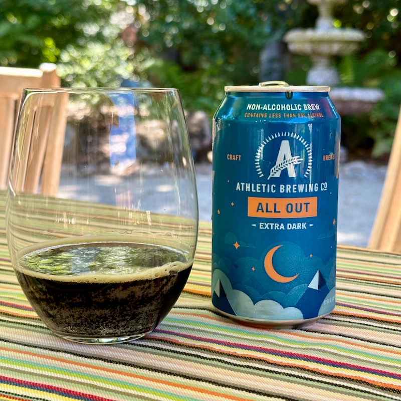 Photo of Athletic Brewing Co. All Out Extra Dark in can and in glass